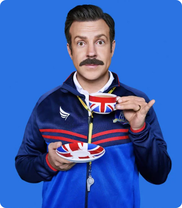 Ted Lasso holding a teacup with Union Jack pattern